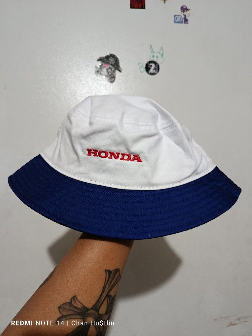Honda Racing HRC Bucket Hat (Category: Caps & Hats) located in Calamba. Submitted by chanmagpantay (Listing ID 1463747483, Image 2). Description: - Official licensed Honda Racing HRC bucket hat - Classic white and blue design - Features prominent Honda Racing HRC logo - Additional Honda logo detail on the side - Ideal for sunny weather protection - A must-have for any Honda enthusiast.