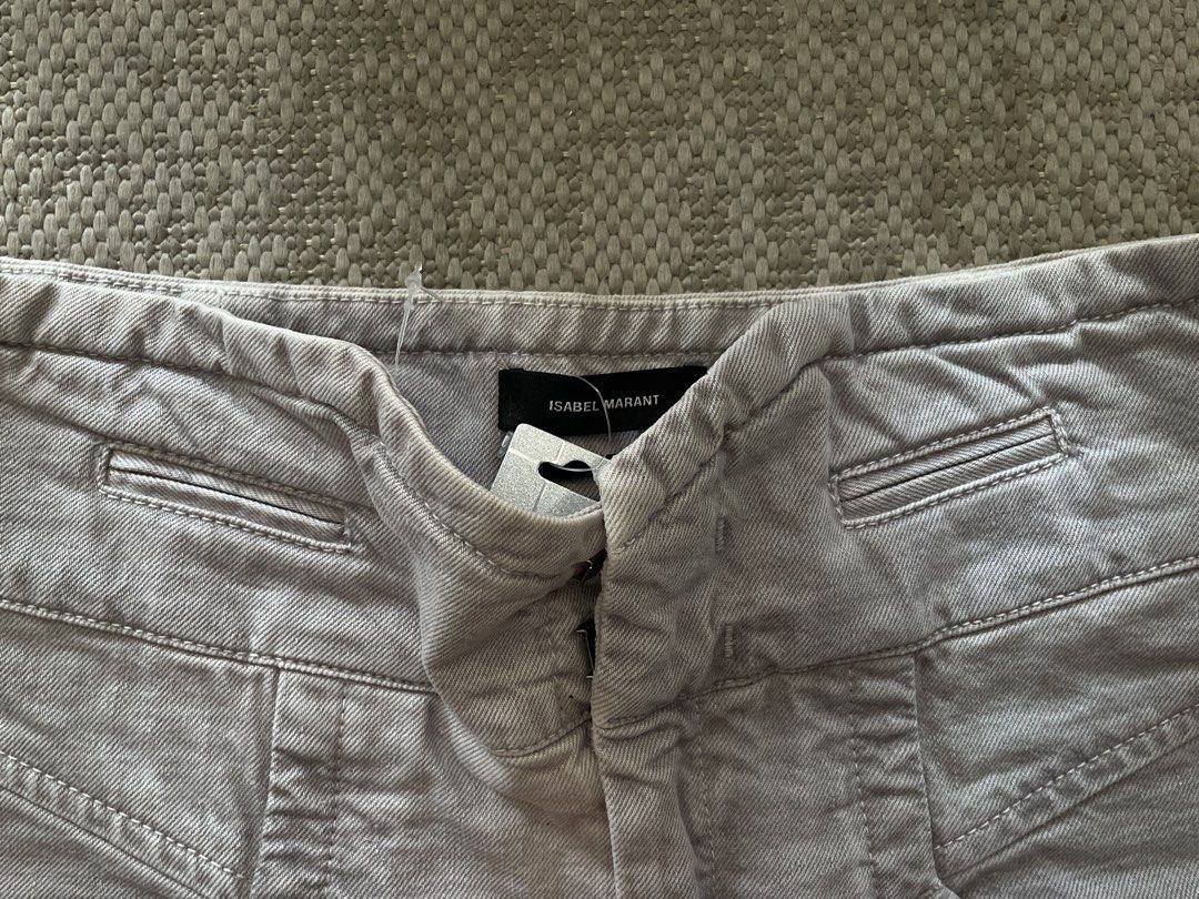 ISABEL MARANT Grey High-Waisted Trousers (Category: Jeans) located in Manila. Submitted by rei.ocn (Listing ID 1463848656, Image 2). Description: - Brand: Isabel Marant - Color: Grey - Style: High-waisted trousers - Closure: Button and zip - Pockets: Unique front pocket details, two button pockets on the back - Details: Eyelet detail at ankle cuffs - Versatility: Great staple piece for your wardrobe.