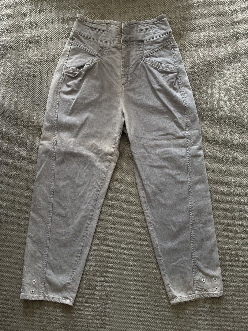 ISABEL MARANT Grey High-Waisted Trousers (Category: Jeans) located in Manila. Submitted by rei.ocn (Listing ID 1463848656, Image 1). Description: - Brand: Isabel Marant - Color: Grey - Style: High-waisted trousers - Closure: Button and zip - Pockets: Unique front pocket details, two button pockets on the back - Details: Eyelet detail at ankle cuffs - Versatility: Great staple piece for your wardrobe.