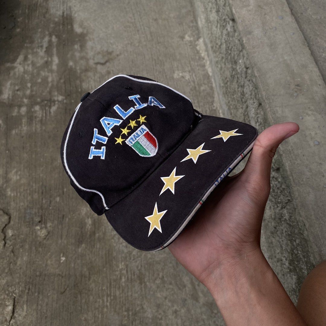 Italia Embroidered Baseball Cap (Category: Caps & Hats) located in Catbalogan. Submitted by thrifttoheaven13 (Listing ID 1463830277, Image 1). Description: - Black baseball cap with 'ITALIA' embroidery on front and back. - Features Italian flag crest and multiple stars. - Material: 100% Cotton. - Made in China. - Adjustable strap for a comfortable fit. - Ideal for football fans and everyday casual wear..