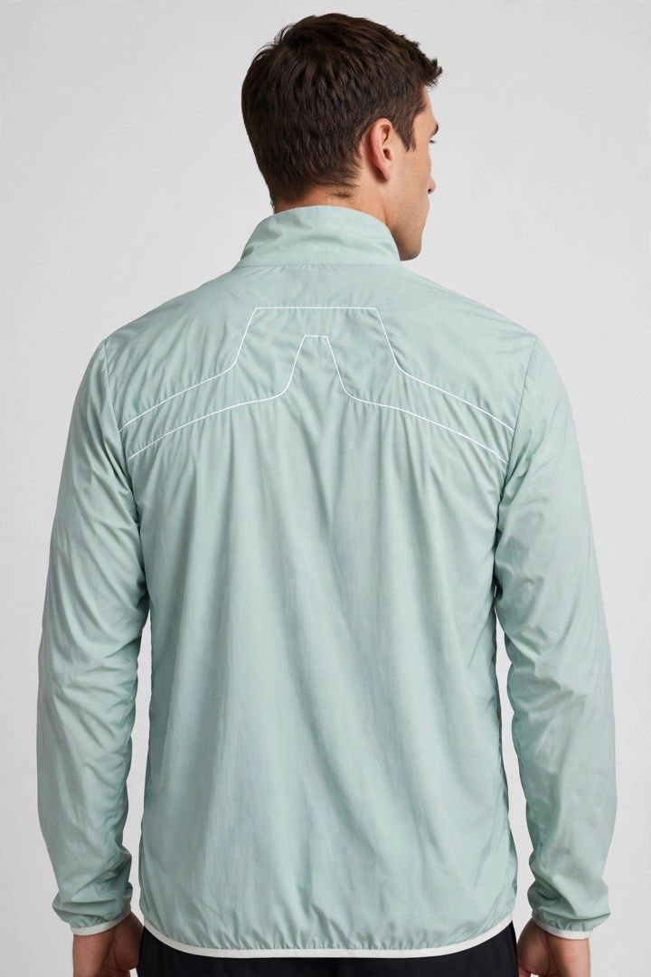 j.lindeberg Light Mint Green Zip-Up Jacket (Category: Coats, Jackets and Outerwear) located in Cateel. Submitted by janicegpad45049 (Listing ID 1463879506, Image 2). Description: - Lightweight J.Lindeberg jacket - Mint green color - Full zip-up front with white zipper - Subtle white piping detail on back and chest - Perfect for layering or light weather - Great for golf or casual wear.