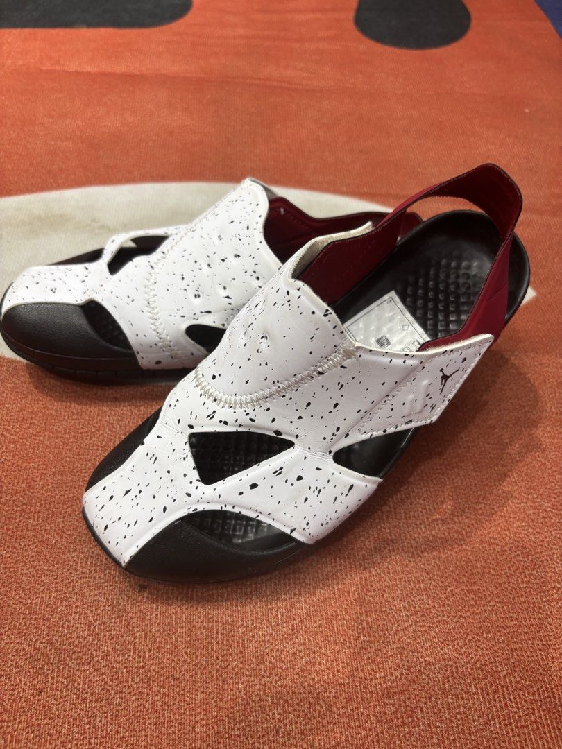 Jordan Flare Sandals (Category: Babies & Kids Fashion) located in Alicia. Submitted by thriftbagph (Listing ID 1463921569, Image 2). Description: - White Jordan sandals for kids - Black speckle print with red accents - Easy slip-on style with secure heel strap - Sole features motivational words: 'Skip', 'Play', 'Jump', 'Run', 'Walk', 'Sprint', 'Dream', 'Learn' - Ideal for active kids and summer fun.