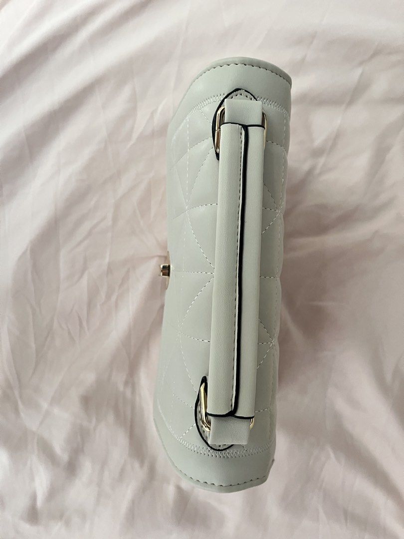 JOVANNI Quilted Handbag with Handle and Strap (Category: Luxury Bags & Wallets) located in Makati City. Submitted by lfaaaaa (Listing ID 1463771955, Image 3). Description: - Off white quilted handbag - Top handle for easy carrying - Detachable shoulder strap for versatility - Secure turn-lock closure - Includes a dust bag for protection - Ideal for everyday use or special events.
