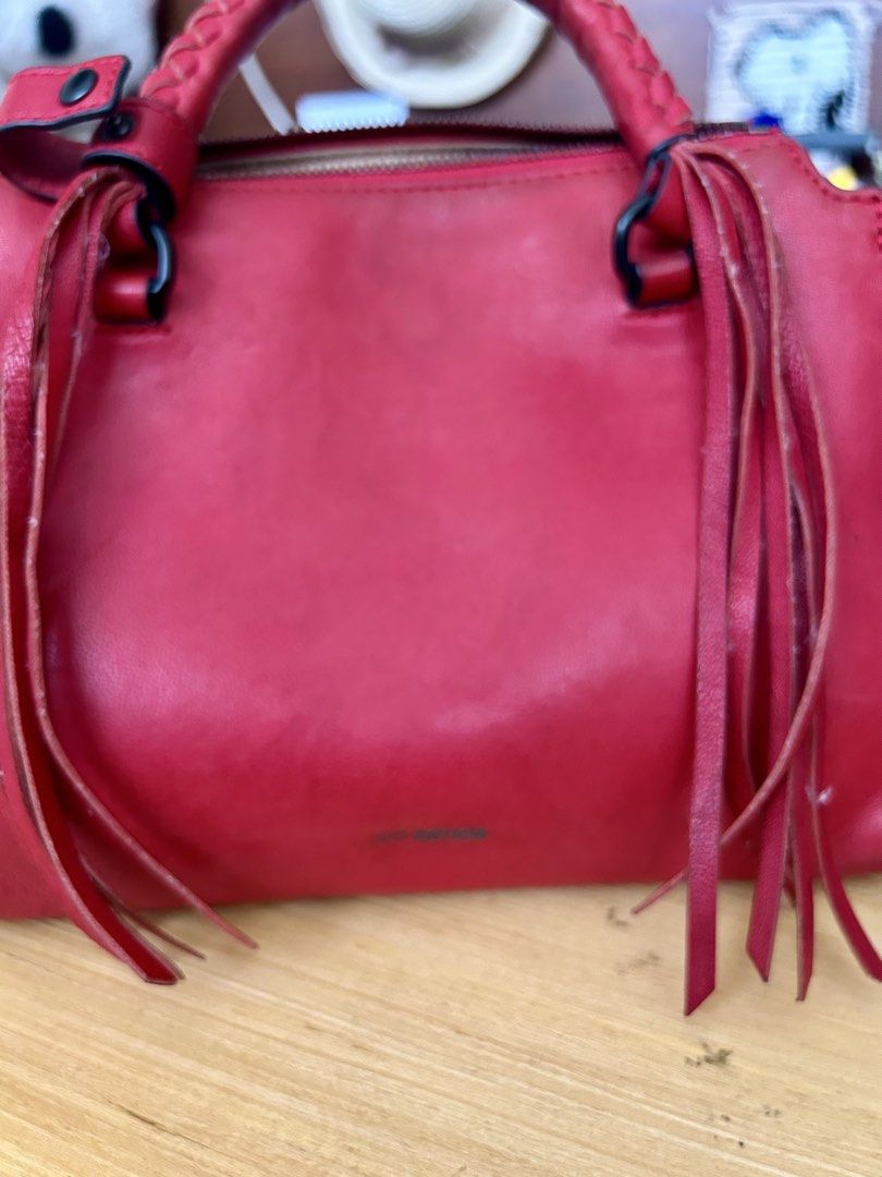 JOY GRYSON natalie (Category: Shoulder Bags) located in Quezon City. Submitted by asiaco (Listing ID 1463778493, Image 2). Description: Chic red leather GRYSON handbag with braided handles and fringe details. Includes a detachable shoulder strap and zipper closure. Perfect for day or night.no flaws, only preloved signs of usage. .