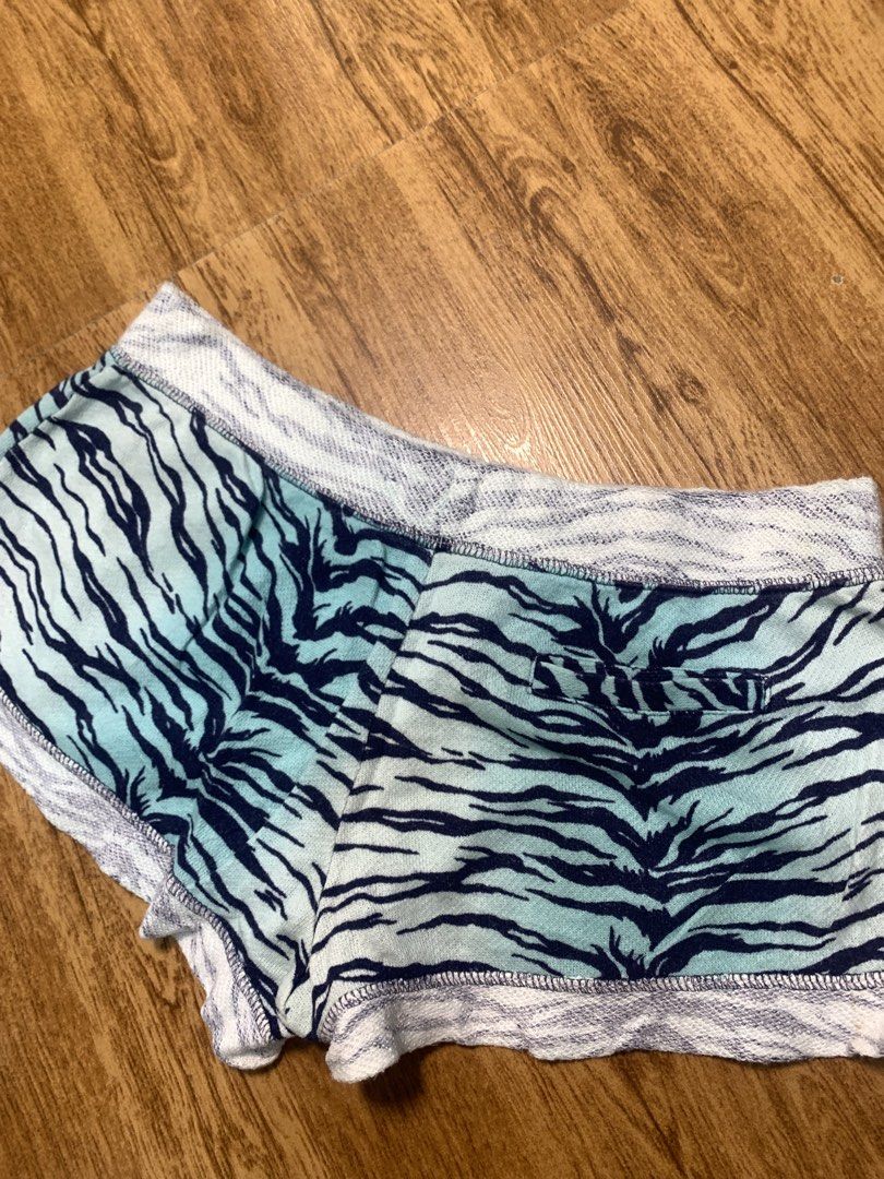 Juicy Couture Tiger Print Shorts with Pink Drawstring (Category: Shorts) located in Davao. Submitted by legitseller1111 (Listing ID 1463783578, Image 3). Description: - Cute Juicy Couture shorts -Size Xs ( Size 28 Adjustable) - Blue and black tiger print - Comfortable elastic waistband - Sparkly pink drawstring - Raw edge hem finish - Small gold 'JUICY' heart charm near hem - Ideal for lounging or casual wear.