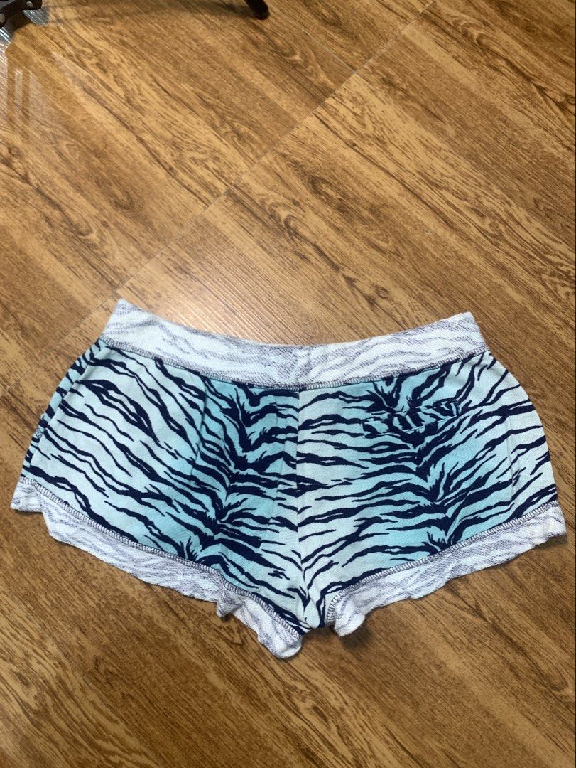 Juicy Couture Tiger Print Shorts with Pink Drawstring (Category: Shorts) located in Davao. Submitted by legitseller1111 (Listing ID 1463783578, Image 2). Description: - Cute Juicy Couture shorts -Size Xs ( Size 28 Adjustable) - Blue and black tiger print - Comfortable elastic waistband - Sparkly pink drawstring - Raw edge hem finish - Small gold 'JUICY' heart charm near hem - Ideal for lounging or casual wear.