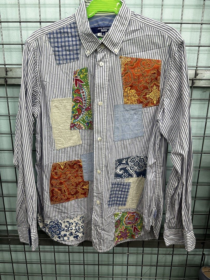 Junya Watanabe MAN Patchwork Striped Shirt (Category: Luxury Apparel) located in Urdaneta. Submitted by redeemedcollective (Listing ID 1463925945, Image 2). Description: Junya Watanabe MAN long-sleeve button-down shirt with navy stripes and mixed fabric patches across the front. Button-down collar and curved hem. Size: S on tag Material: 100% cotton main fabric; mixed patchwork fabrics Made in Japan Style code: WI-B002 Condition: Pre-owned. Pleas