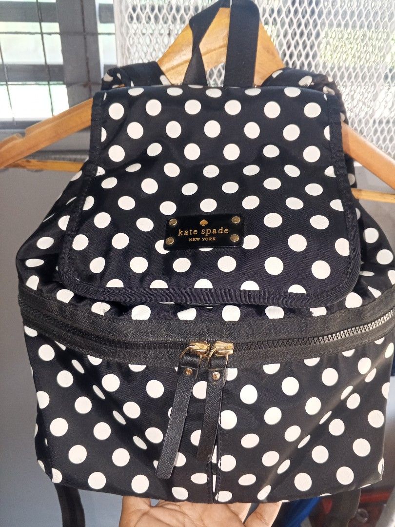 Kate Spade New York Polka Dot Backpack (Category: Luxury Bags & Wallets) located in Magalang. Submitted by zeiansoria64090 (Listing ID 1463748508, Image 1). Description: - Stylish black backpack with a playful white polka dot pattern. - Features a convenient front zip pocket for quick access. - Spacious main compartment to hold your essentials. - Elegant gold hardware details add a touch of luxury. - Adjustable straps ensure a comfortable fit for