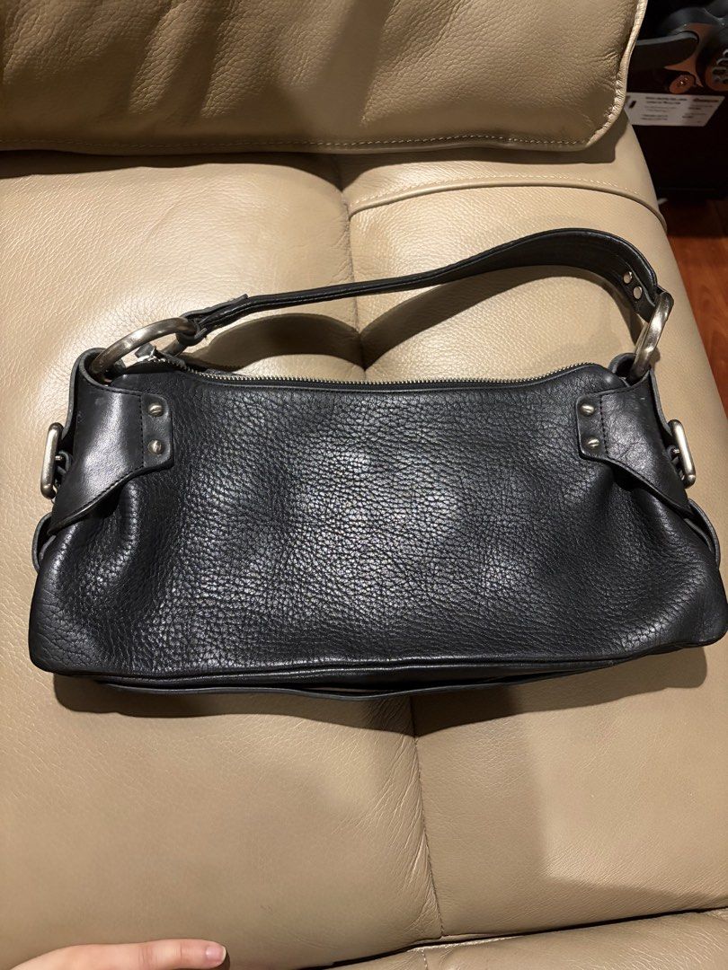 Kenneth Cole Black Leather Shoulder Bag (Category: Shoulder Bags) located in Quezon City. Submitted by yarnhillmanila (Listing ID 1463866520, Image 2). Description: - Brand: Kenneth Cole - Color: Black - Material: Leather - Texture: Pebbled - Hardware: Silver - Closure: Zipper - Style: Classic, versatile for everyday wear.