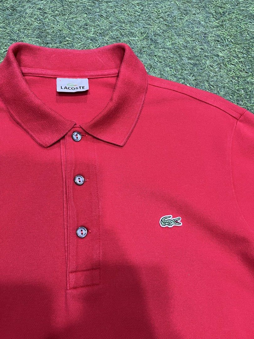 Lacoste Red Polo Shirt Size 4 (Category: Tshirts & Polo Shirts ) located in Balamban. Submitted by gogochrist09668 (Listing ID 1463894585, Image 2). Description: - Classic red Lacoste polo shirt - Iconic embroidered crocodile logo on chest - Two-button placket with grey buttons - Size: 4 19W 25L - Material: Comfortable cotton - Style: Great for casual or smart-casual looks.