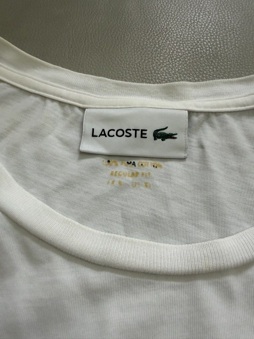 Lacoste White T-Shirt for men’s (Category: Tshirts & Polo Shirts ) located in Quezon City. Submitted by vaniefiel (Listing ID 1463780445, Image 3). Description: For Sale! Authentic - Lacoste t-shirt - Iconic green crocodile logo embroidered on chest - Made from 100% cotton for ultimate comfort - Regular fit for a comfortable silhouette - Tag indicates origin from Hong Kong - issue pinhole upper left shoulder - Check pictures for actual size dimen