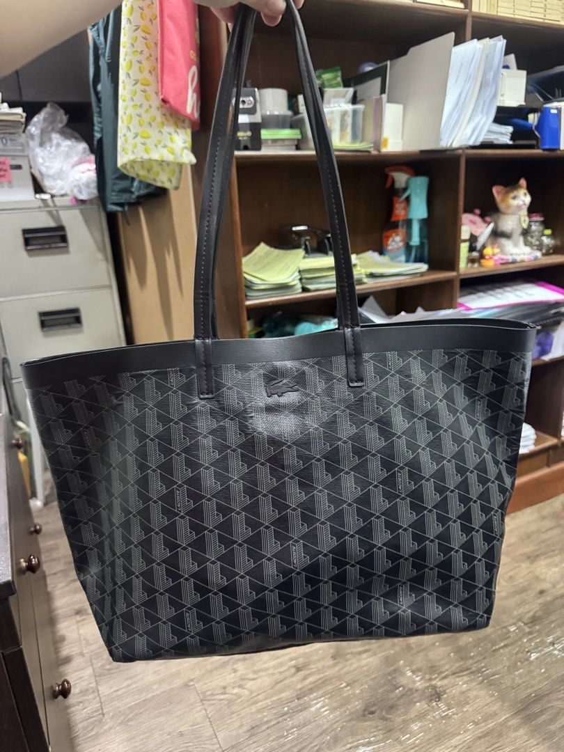 Lacoste zely tote bag (Category: Tote Bags) located in Valenzuela. Submitted by Pinkantshoppe (Listing ID 1463833307, Image 2). Description: - Pls manage your expectation, this is a preloved item - don't offer kung hindi nmn kukunin pls. - Classic black tote bag - Repeating geometric monogram pattern - Genuine leather handles and trim - Spacious interior, ideal for everyday or travel - Simple and timeless design.