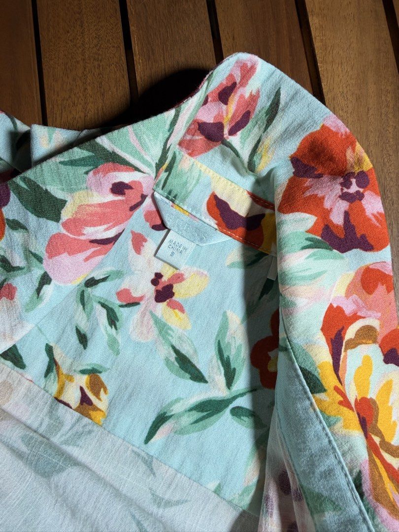 Light Blue Floral Tie-Front Blouse (Category: Blouses) located in Tuguegarao City. Submitted by joysmithznjo (Listing ID 1463746656, Image 2). Description: - Light blue blouse with vibrant floral print - Tie-front detail at the hem - Smocked cuffs - Button-up front - High collar - Lightweight fabric - Versatile: pairs well with jeans or skirts.
