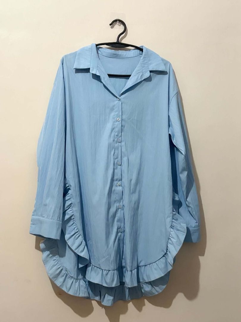 Light Blue Oversized Ruffle Hem Button-Up Shirt (Category: Blouses) located in San Leonardo. Submitted by burgossanleonardo.12345 (Listing ID 1463863832, Image 1). Description: - Oversized button-up shirt - Light blue color - Collared neckline - Long sleeves - Cute ruffled hem detail - Versatile for casual or dressed-up outfits - Easy to style.