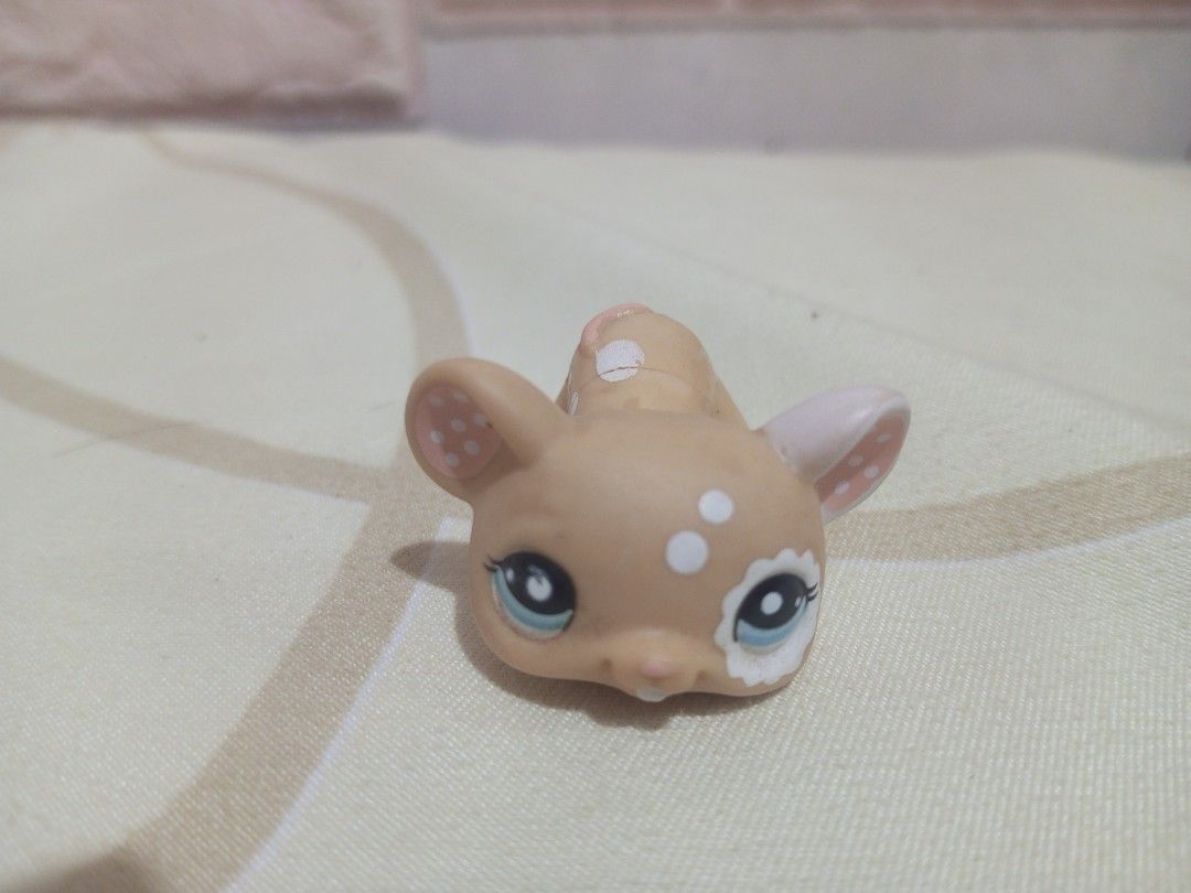 Littlest Pet Shop Deer Toy (Category: Kids Toys) located in Victorias. Submitted by tobylacua26871 (Listing ID 1463864385, Image 1). Description: - Cute Littlest Pet Shop deer toy - Light brown with white spots - Adorable blue eyes - Minor purple markings on one leg - Head and body are separate pieces - Ideal for Littlest Pet Shop collectors.