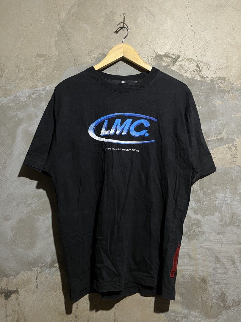 LMC Lost Management Cities Black T-shirt (Category: Tshirts & Polo Shirts ) located in Manila. Submitted by rylthriftz12 (Listing ID 1463893436, Image 1). Description: - Black LMC t-shirt - Blue and white graphic logo with 'LOST MANAGEMENT CITIES' text - Short sleeves - Crew neck - Red tag detail on the side - Ideal for casual wear.
