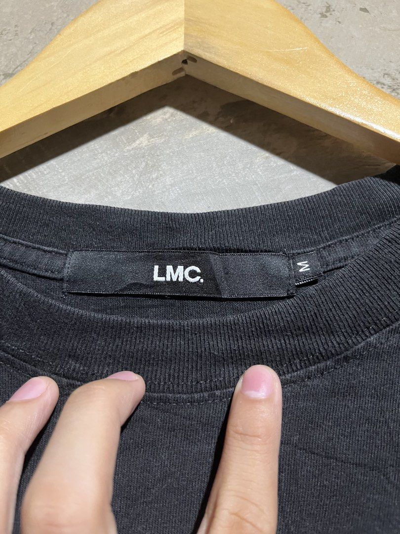 LMC Lost Management Cities Black T-shirt (Category: Tshirts & Polo Shirts ) located in Manila. Submitted by rylthriftz12 (Listing ID 1463893436, Image 3). Description: - Black LMC t-shirt - Blue and white graphic logo with 'LOST MANAGEMENT CITIES' text - Short sleeves - Crew neck - Red tag detail on the side - Ideal for casual wear.