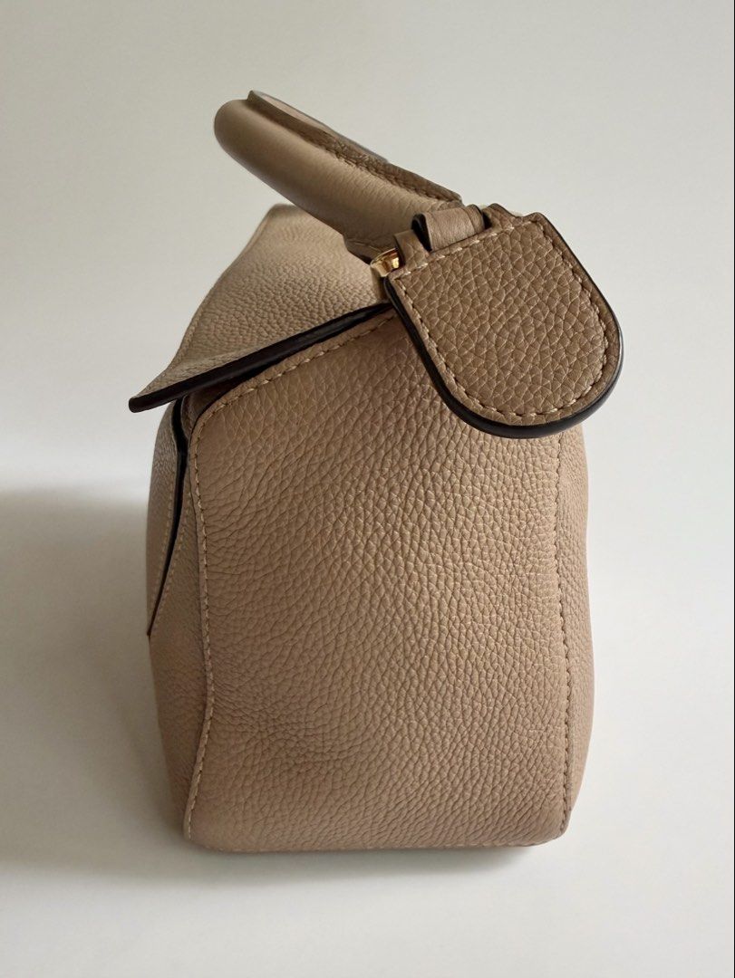 Loewe Puzzle Small in Sand (Category: Luxury Bags & Wallets) located in Quezon City. Submitted by lian_closet (Listing ID 1463770243, Image 2). Description: Loewe Puzzle Small in Sand Best Price: ₱76,000 Preloved Comes with Detachable Strap, Dust Bag & LegitGrails Authenticity Certificate Preloved Rating: 8.2/10 Excellent but shows signs of wear Cracks on leather by the handle Interior is clean.