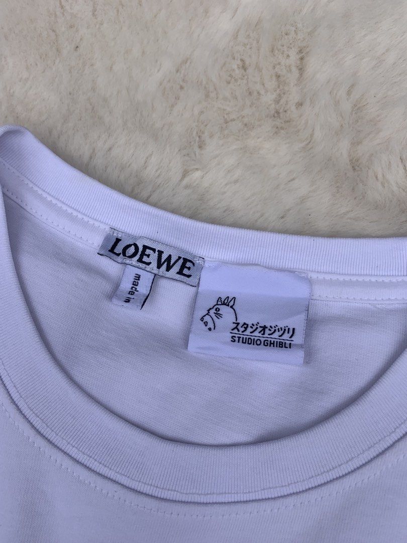 LOEWE x Studio Ghibli White T-shirt (Category: Shirts) located in Cateel. Submitted by janicegpad45049 (Listing ID 1463881314, Image 3). Description: - Authentic LOEWE x Studio Ghibli Collaboration T-Shirt - Color: White - Material: Soft Cotton - Features a cute Studio Ghibli embroidered graphic on the chest - Made in Portugal - Versatile: Pairs well with jeans or shorts - Ideal for fans of both LOEWE and Studio Ghibli.