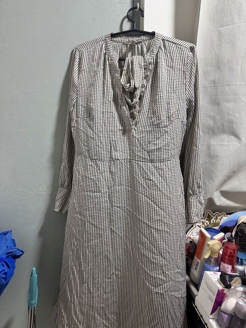 Long Sleeve Printed V-Neck Dress (Category: Dresses) located in Manila. Submitted by _aabbybimbap (Listing ID 1463901968, Image 1). Description: - Long-sleeved dress - V-neckline with tie-up detail - Small, vertical black and white print - Cinched waist for a flattering silhouette - Functional buttons down the front - Versatile for everyday wear, easily dressed up or down.