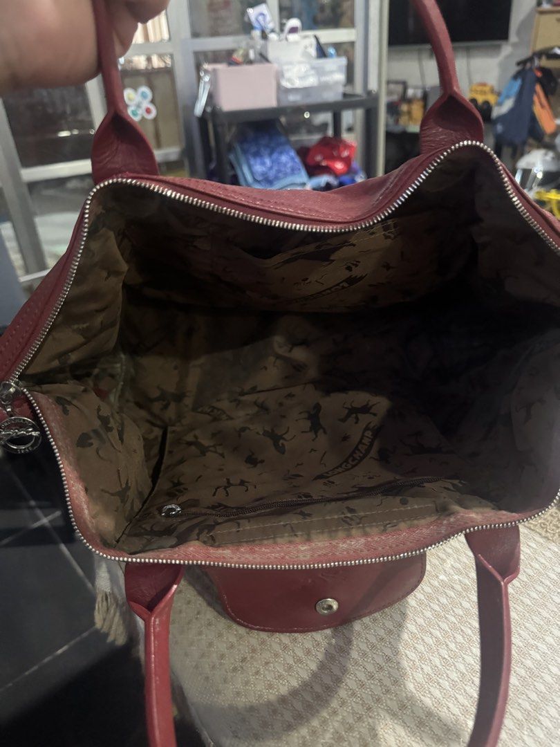 Longchamp Paris Red Leather Tote Bag (Category: Luxury Bags & Wallets) located in Valenzuela. Submitted by Pinkantshoppe (Listing ID 1463933775, Image 3). Description: - Authentic Longchamp Paris red leather tote bag - Signature horse and rider print lining - Zippered main compartment - Front flap pocket with snap closure - Genuine leather handles - Made in China.
