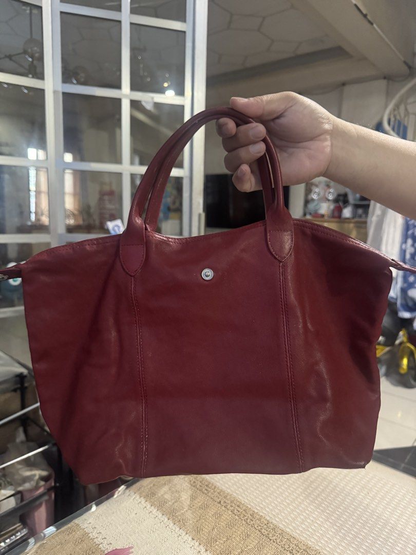 Longchamp Paris Red Leather Tote Bag (Category: Luxury Bags & Wallets) located in Valenzuela. Submitted by Pinkantshoppe (Listing ID 1463933775, Image 1). Description: - Authentic Longchamp Paris red leather tote bag - Signature horse and rider print lining - Zippered main compartment - Front flap pocket with snap closure - Genuine leather handles - Made in China.