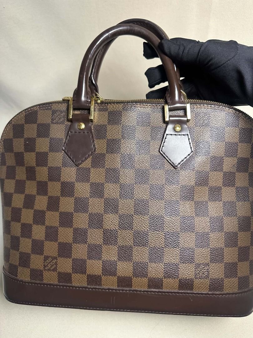 Louis Vuitton Alma PM (Category: Luxury Bags & Wallets) located in Caloocan City. Submitted by anewchapterluxx (Listing ID 1463776934, Image 2). Description: LV Damier Ebene Alma PM INCLUSIONS: - certificate of authenticity - dust bag CONDITION: B+ Rank 8/10 (Good Condition) - Authentic Louis Vuitton Alma bag - Classic Damier Ebene canvas with brown leather trim - Iconic checkered pattern - Secure zipper closure - Versatile for everyday or specia