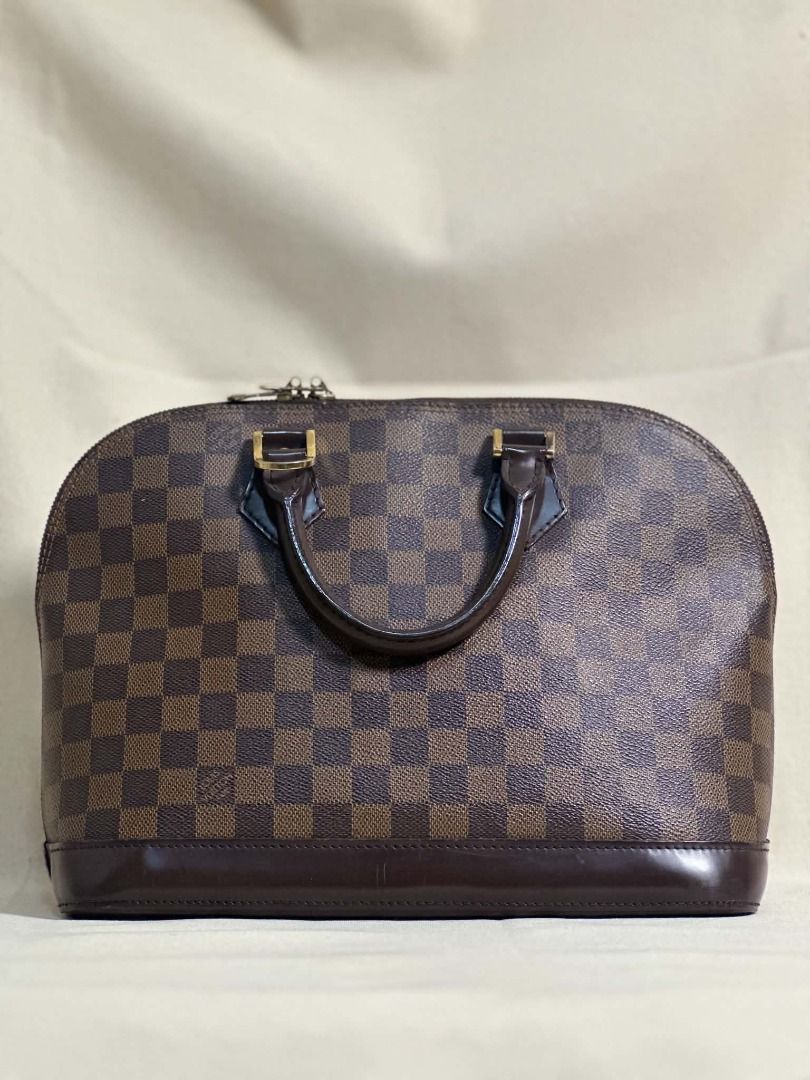 Louis Vuitton Alma PM (Category: Luxury Bags & Wallets) located in Caloocan City. Submitted by anewchapterluxx (Listing ID 1463776934, Image 1). Description: LV Damier Ebene Alma PM INCLUSIONS: - certificate of authenticity - dust bag CONDITION: B+ Rank 8/10 (Good Condition) - Authentic Louis Vuitton Alma bag - Classic Damier Ebene canvas with brown leather trim - Iconic checkered pattern - Secure zipper closure - Versatile for everyday or specia