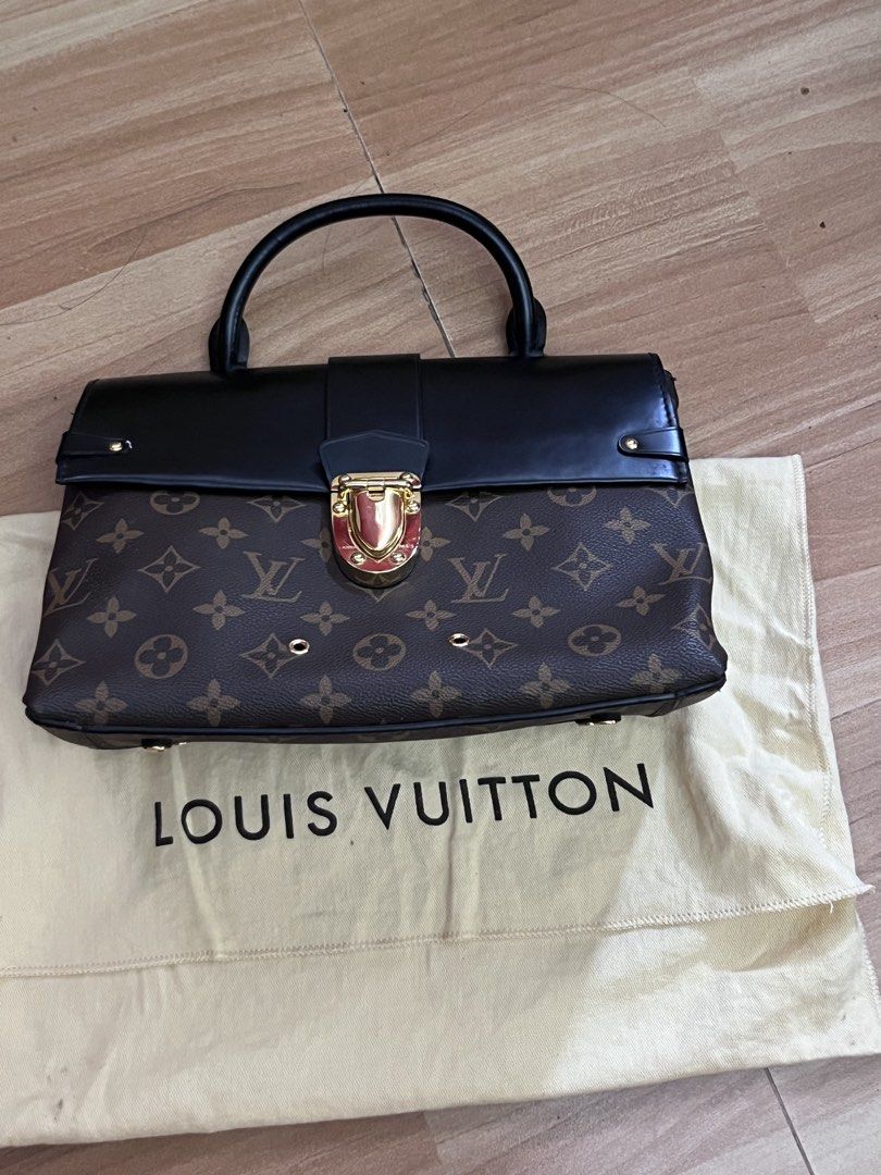 Louis Vuitton Monogram Canvas & Leather Top Handle Bag (Category: Luxury Bags & Wallets) located in Victorias. Submitted by lan1877 (Listing ID 1463797312, Image 1). Description: - Classic Louis Vuitton Monogram canvas - Black leather accents - Gold hardware details - Top handle for carrying - Includes original dust bag - Versatile for everyday or special events Issue missing sling.