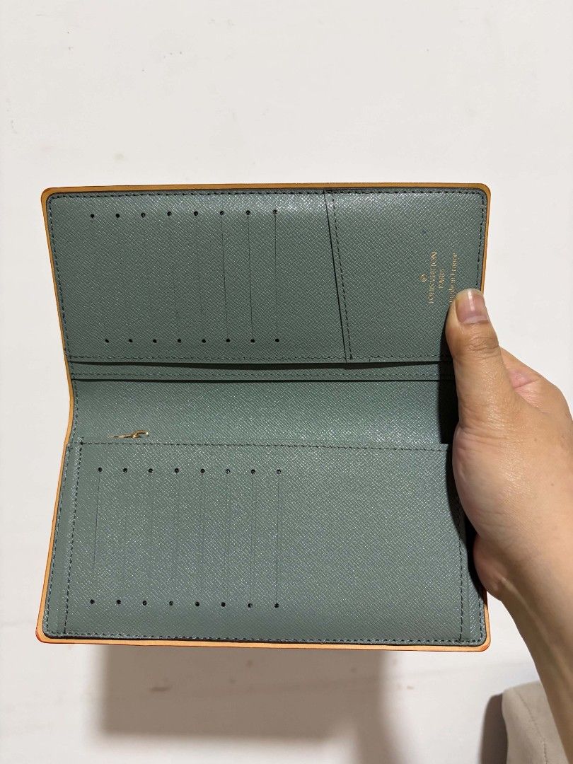 Louis Vuitton Monogram Long Wallet (Category: Luxury Bags & Wallets) located in Polomolok. Submitted by legadad94559 (Listing ID 1463923291, Image 2). Description: - Authentic Louis Vuitton long wallet - Stylish grey monogram canvas with vibrant orange trim - Ample card slots for all your cards - Convenient zippered compartment for secure storage - Immaculate interior, well-maintained - Ideal for keeping your essentials neatly organized.