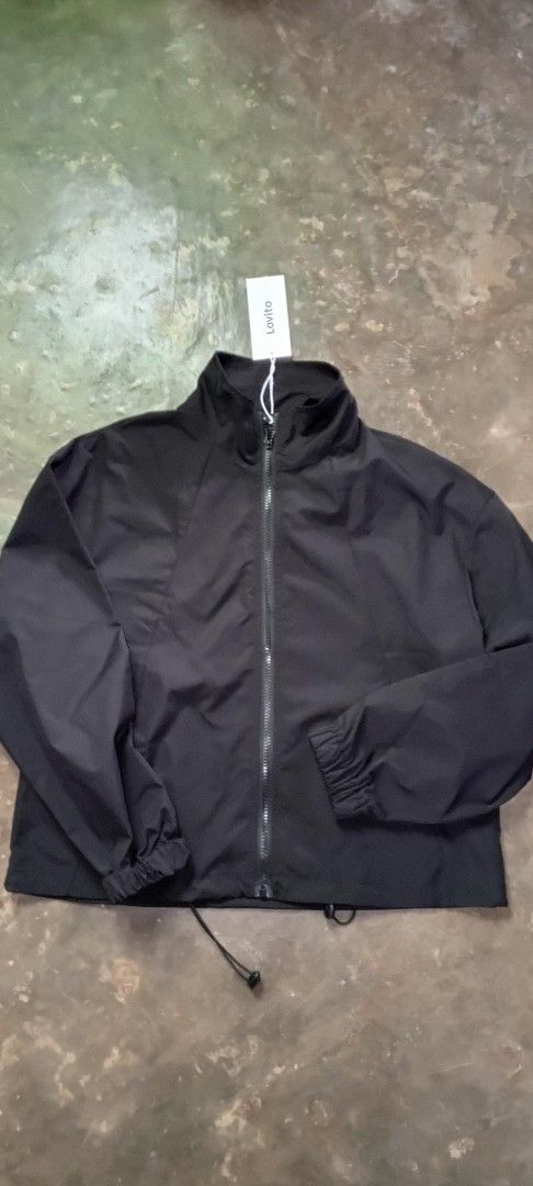 Lovito Black Zip-Up Jacket (Category: Coats, Jackets and Outerwear) located in Manila. Submitted by ezekislacl02490 (Listing ID 1463784750, Image 1). Description: - Lovito black zip-up jacket - Features a high collar - Elasticated cuffs and hem - Drawstring at the bottom hem - Lightweight, windbreaker-like material - Ideal for layering or casual outfits.