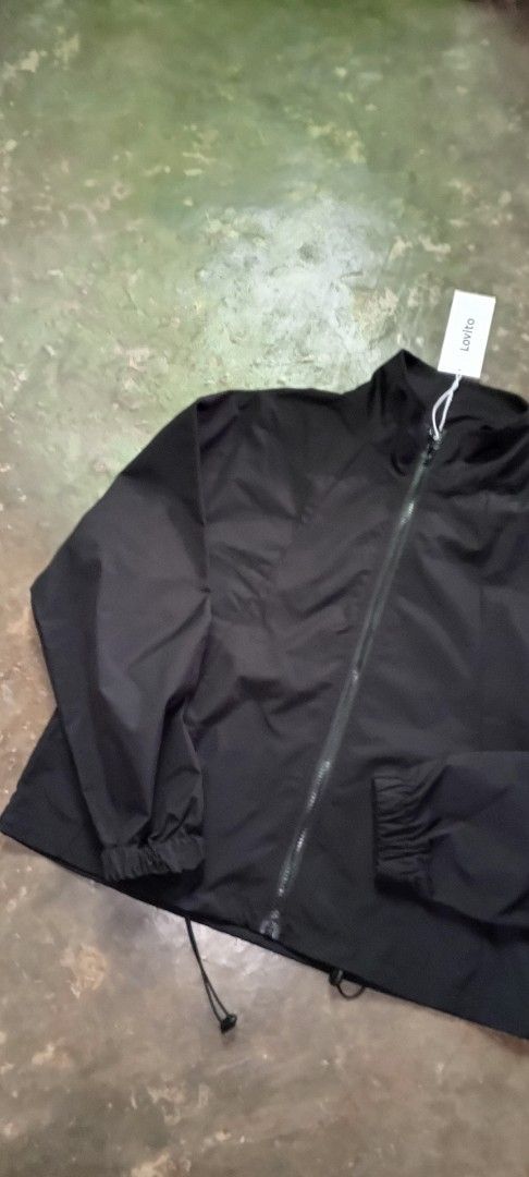 Lovito Black Zip-Up Jacket (Category: Coats, Jackets and Outerwear) located in Manila. Submitted by ezekislacl02490 (Listing ID 1463784750, Image 2). Description: - Lovito black zip-up jacket - Features a high collar - Elasticated cuffs and hem - Drawstring at the bottom hem - Lightweight, windbreaker-like material - Ideal for layering or casual outfits.