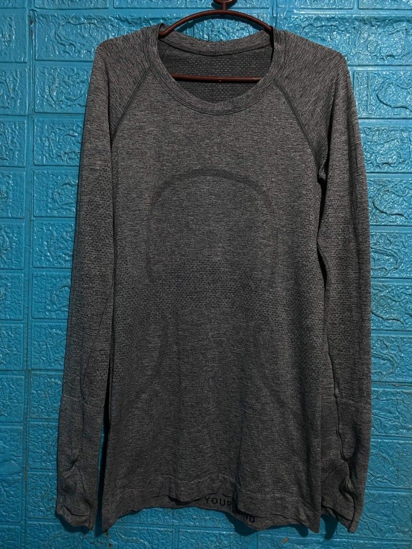 Lululemon Long Sleeve Athletic Shirt Grey (Category: Longsleeves) located in Las Pinas. Submitted by solisjethr46316 (Listing ID 1463853987, Image 2). Description: - Grey Lululemon long sleeve shirt - Made with seamless knit fabric - Features raglan sleeves for enhanced comfort - Includes thumbholes on the cuffs - Versatile for workouts or casual wear - Minimal branding.