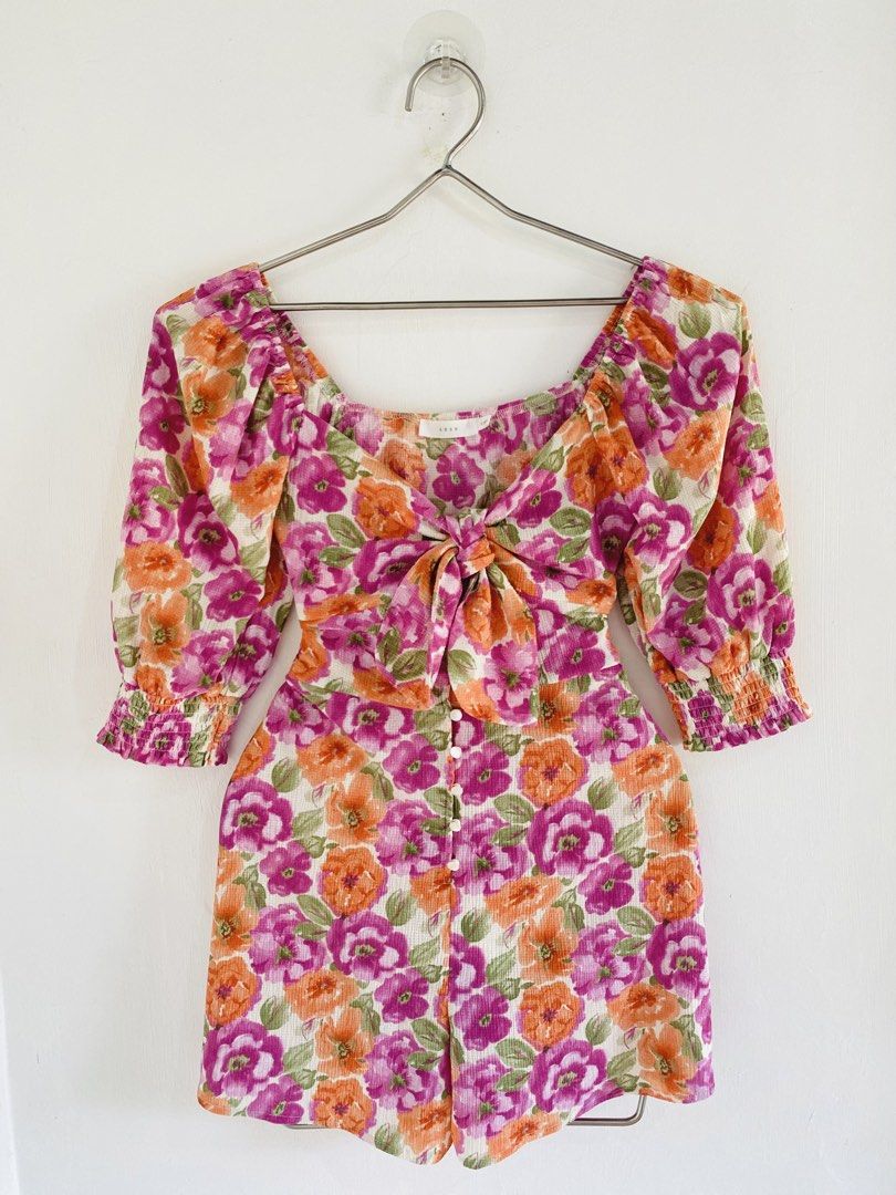 LUSH Floral Tie Front Romper (Category: Rompers) located in Vigan. Submitted by yourcloset1001 (Listing ID 1463912728, Image 1). Description: - Brand: LUSH - Style: Floral Romper - Features: Tie front detail, square neckline, puff sleeves with elastic cuffs - Closure: Button front - Occasion: Perfect for day outs, casual events, and summer wear.
