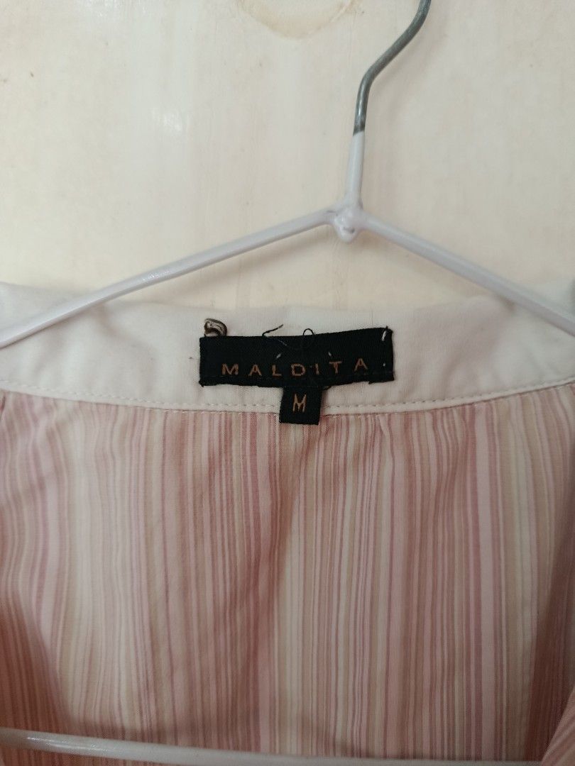 Maldita Striped Sleeveless Collared Top Size M (Category: Sleeveless) located in Manila. Submitted by tyrrachuuu (Listing ID 1463769238, Image 3). Description: - Maldita top - Size: Medium (M) - Pattern: Pink and white stripes - Design: Sleeveless with a collar - Closure: Button-up front - Versatile: Great for casual wear or dressing up.