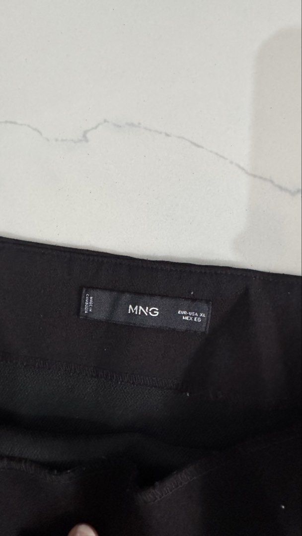 Mango Black Mini Skirt (Category: Skirts) located in Manila. Submitted by patc20 (Listing ID 1463813242, Image 2). Description: - Brand: MNG - Color: Black - Style: Mini Skirt - Tag Size: XL - Waist Measurement (flat): Approx. 18 inches - Length: Approx. 16 inches - Design: Simple and classic - Occasion: Suitable for casual or dressy events.
