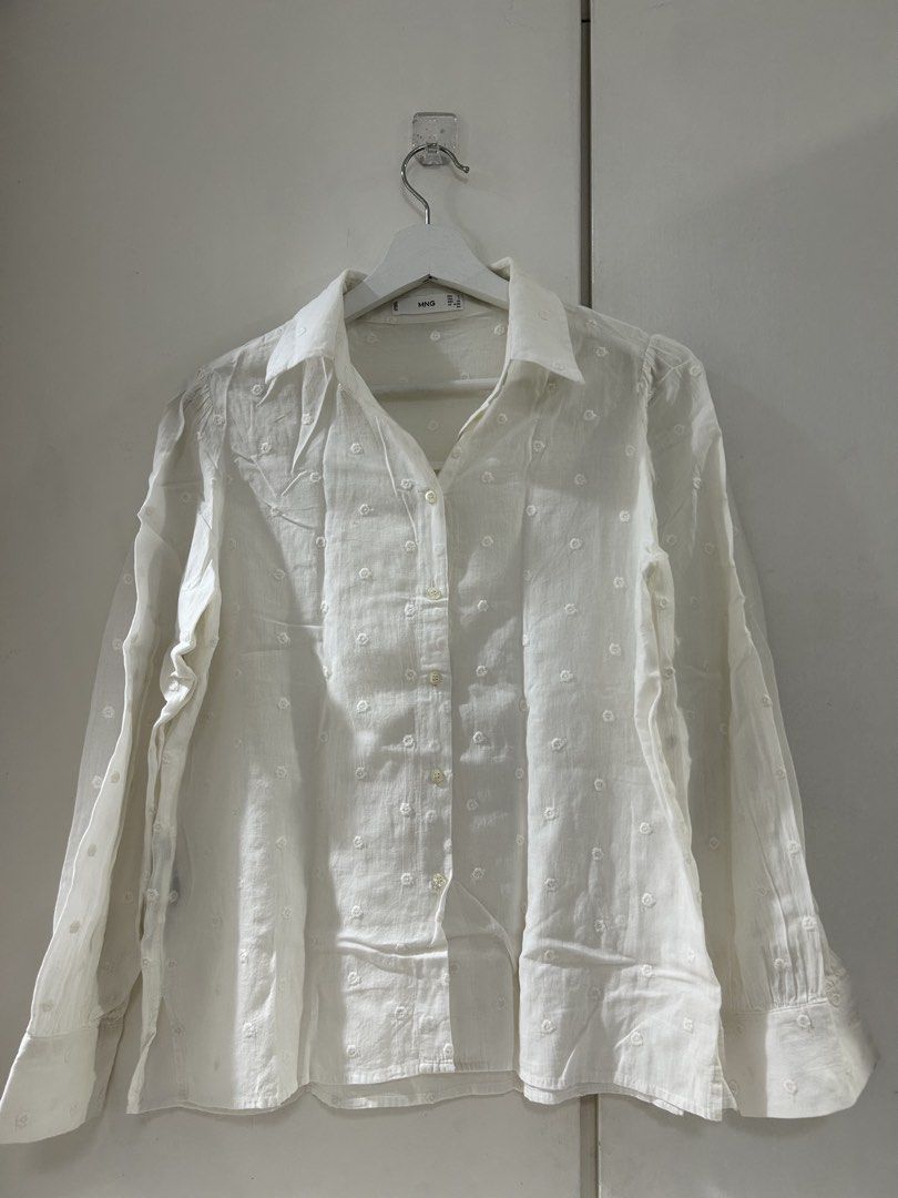 Mango White Embroidered Button-Up Shirt (Category: Shirts) located in Manila. Submitted by isabelle_1104 (Listing ID 1463891970, Image 1). Description: - White MNG shirt - Subtle embroidered floral details all over - Classic button-up style with collar - Long sleeves with button cuffs - Lightweight material, perfect for layering or wearing solo - Easy to dress up or down.