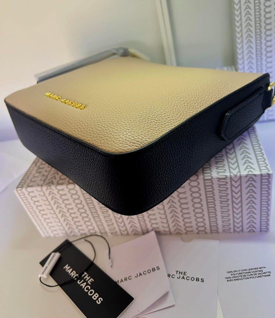 Marc Jacobs Drifter Swing Crossbody Bag (Category: Luxury Bags & Wallets) located in Abucay. Submitted by erindeclutterss (Listing ID 1463855668, Image 3). Description: - Authentic Marc Jacobs camera bag - Chic black and beige colorblock design - Elegant gold hardware with signature lock detail - Comes with a detachable crossbody strap for versatile wear - Original dust bag and box included.