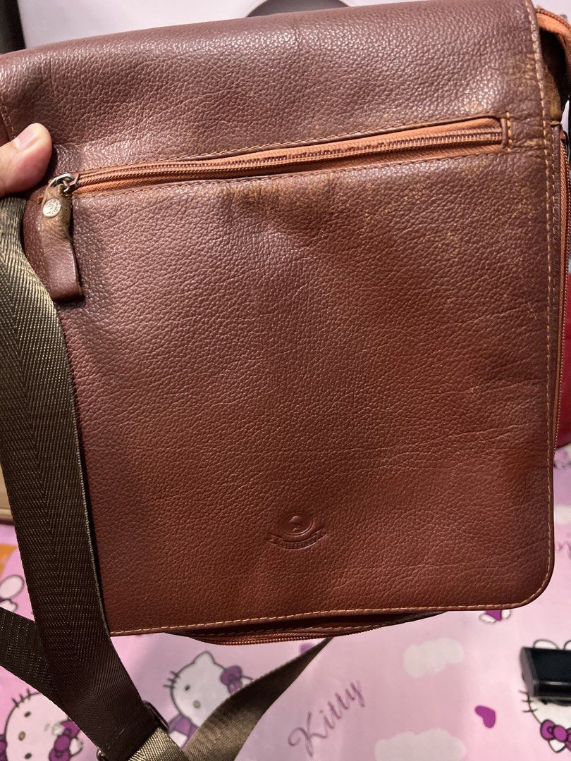 Mcjim Leather Sling Bag (Category: Sling Bags) located in Quezon City. Submitted by iamace2006 (Listing ID 1463862342, Image 1). Description: - Stylish brown leather crossbody bag - Features a zippered front pocket - Spacious main compartment - Adjustable strap for comfortable wear.