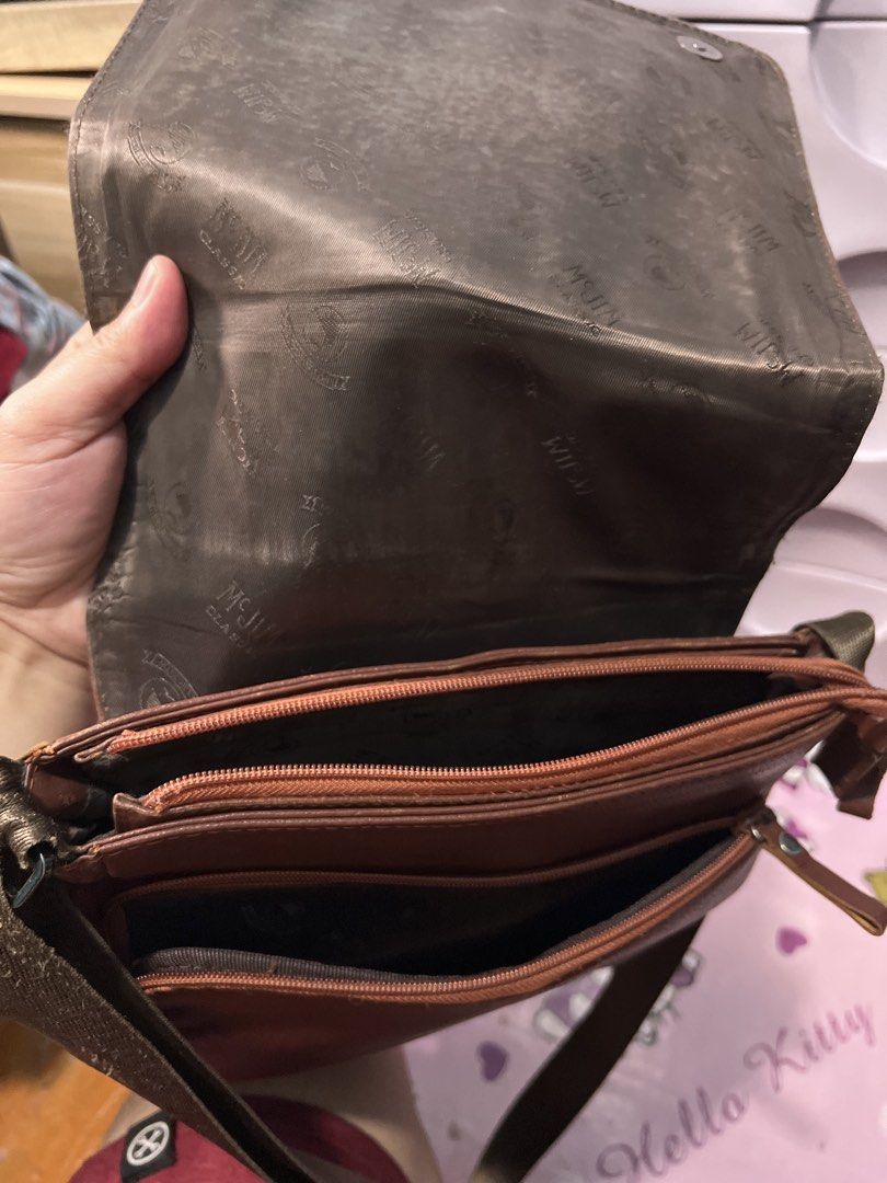 Mcjim Leather Sling Bag (Category: Sling Bags) located in Quezon City. Submitted by iamace2006 (Listing ID 1463862342, Image 2). Description: - Stylish brown leather crossbody bag - Features a zippered front pocket - Spacious main compartment - Adjustable strap for comfortable wear.
