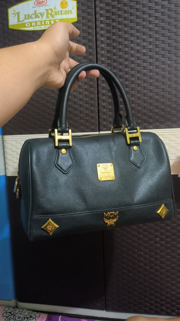 MCM Black Leather Boston Bag (Category: Luxury Bags & Wallets) located in Quezon City. Submitted by 88bagelya_ni_rhen88 (Listing ID 1463756498, Image 1). Description: - Classic MCM Boston bag - Black leather with textured finish - Iconic MCM logo detailing - Gold hardware accents - Structured design, ideal for everyday or travel - Spacious interior - Comfortable top handles - Preloved From Japan.