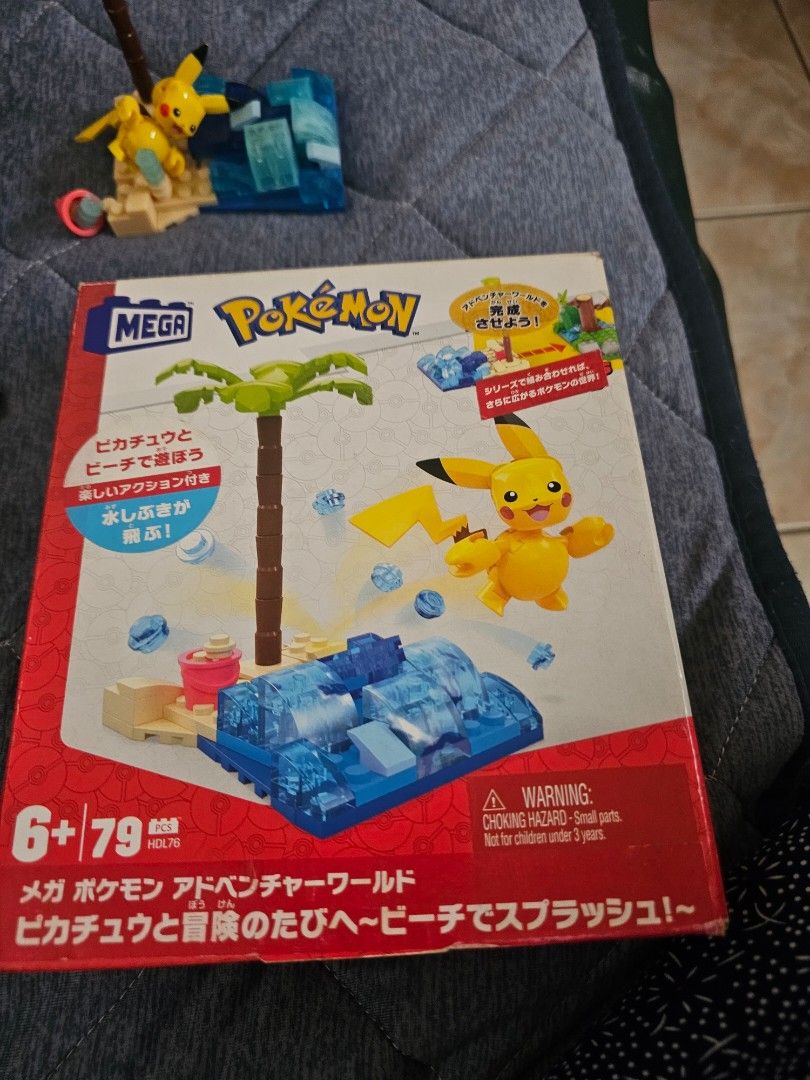 Mega Construx Pokemon Pikachu's Beach Splash Building Set HDL76 (Category: Lego & Building Sets) located in Muntinlupa City. Submitted by jojiepogi123 (Listing ID 1463769158, Image 2). Description: - Mega Construx Pokemon Building Set - Features Pikachu on a beach with palm tree and water - Includes building blocks and a Pikachu figure - Box displays a larger scene with other Pokemon characters (not included) - Instructions included - Perfect for