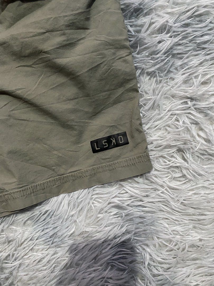Men's LSKD Daily Shorts 7" (Category: Shorts) located in Carmen. Submitted by yawbuangaka (Listing ID 1463797056, Image 3). Description: These are the LSKD Daily Shorts in an dust olive shade, featuring an elastic drawstring waistband and a small black logo patch near the hem. •Small •Waistline - 30 •Length - 16 •In very good condition.
