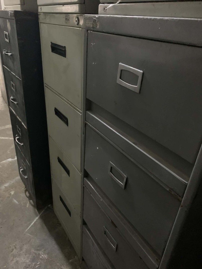 Metal Filing Cabinet - 4 Drawers (Category: Office Furniture & Fixtures) located in Manila. Submitted by cleverocean.10acf9 (Listing ID 1463766060, Image 3). Description: Four-drawer metal filing cabinet. Gray color. Some scratches and scuffs from use. Still functional and sturdy. Great for organizing documents and office supplies. Measures approximately [infer dimensions if possible]..
