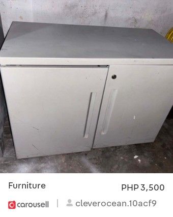 Metal Filing Cabinet - 4 Drawers (Category: Office Furniture & Fixtures) located in Manila. Submitted by cleverocean.10acf9 (Listing ID 1463766060, Image 1). Description: Four-drawer metal filing cabinet. Gray color. Some scratches and scuffs from use. Still functional and sturdy. Great for organizing documents and office supplies. Measures approximately [infer dimensions if possible]..