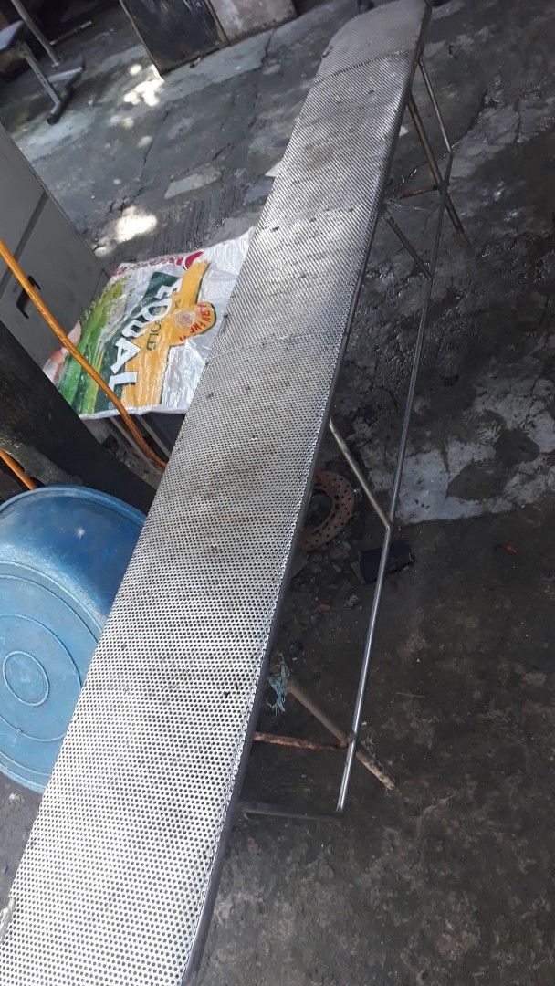 Metal Perforated Bench (Category: Office Furniture & Fixtures) located in Quezon City. Submitted by madelrivera (Listing ID 1463837684, Image 3). Description: - Long metal bench with a perforated surface - Sturdy metal legs for excellent support - Ideal for outdoor or industrial environments - Shows some signs of wear, but remains fully functional - Versatile for seating or as a utility surface.