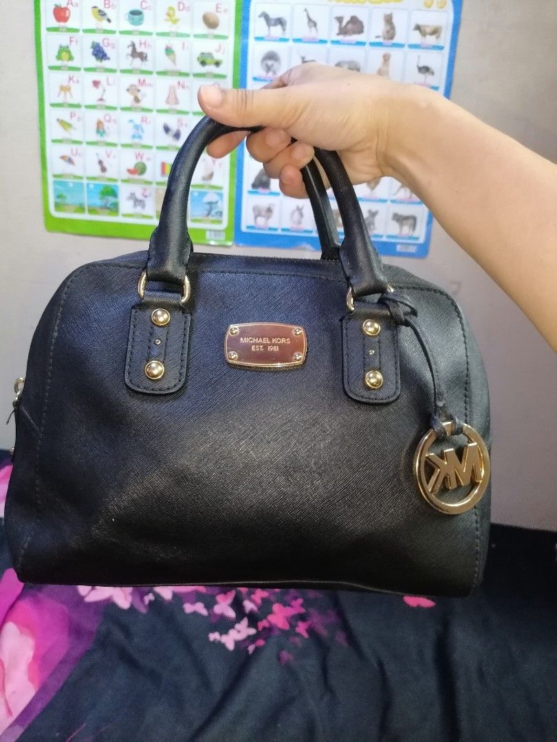 Michael Kors Black Leather Satchel Handbag (Category: Luxury Bags & Wallets) located in Digos. Submitted by crodualady82694 (Listing ID 1463757315, Image 1). Description: - Authentic Michael Kors black leather satchel bag - Elegant gold hardware details - Signature Michael Kors logo lining inside - Secure zipper closure - Ideal for daily use.