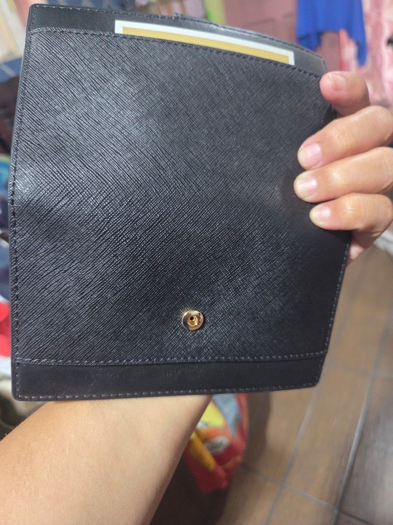Michael Kors Black Leather Wallet (Category: Wallets & Card holders) located in Manila. Submitted by analiepagl91301 (Listing ID 1463817775, Image 2). Description: - Authentic Michael Kors wallet in black - Crafted from premium textured leather - Secure snap closure for peace of mind - Convenient interior zip compartment for coins or small items - Numerous card slots to hold all your cards - Clear ID window for easy access - Elegant gold-tone Mic