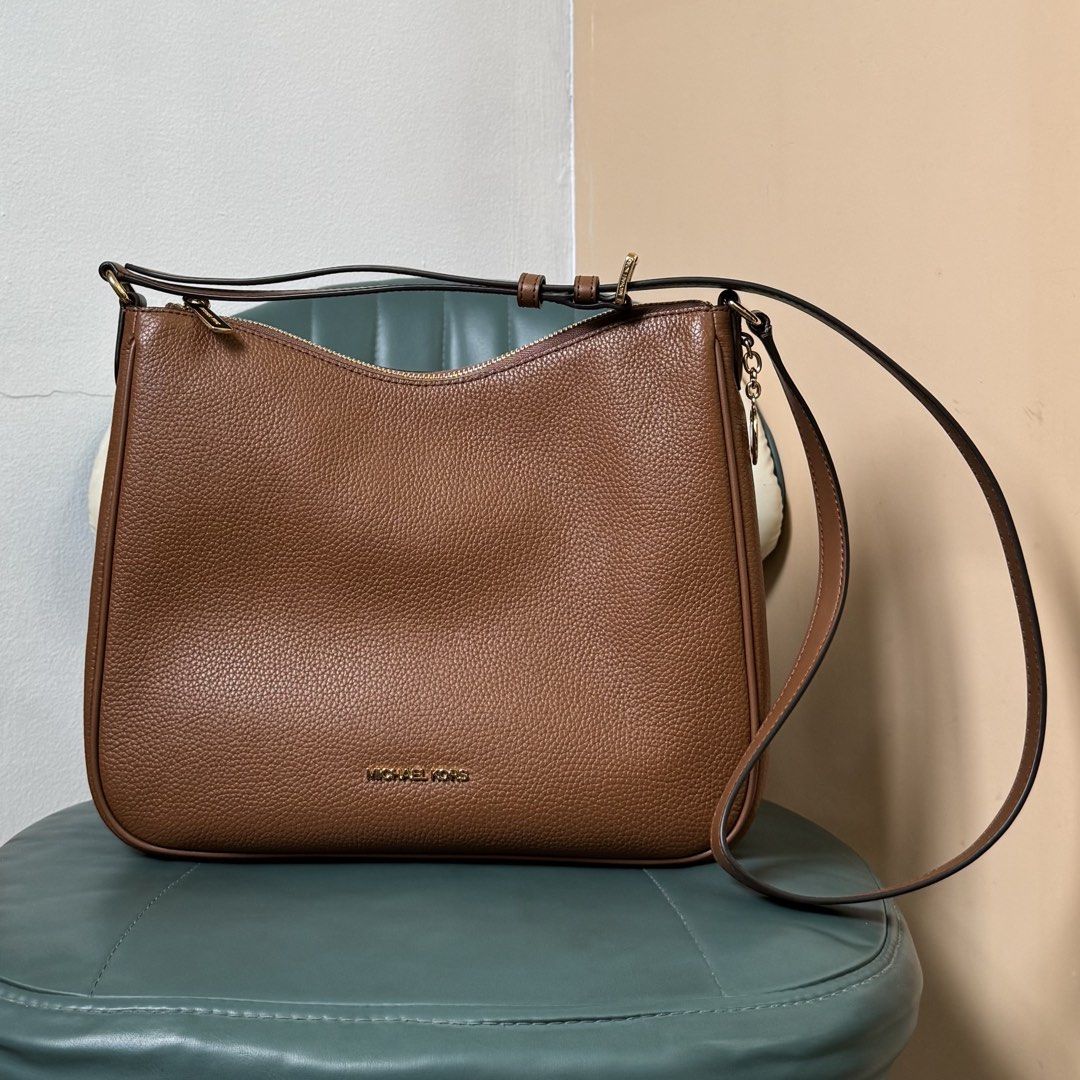 Michael Kors Brown Leather Shoulder Bag (Category: Luxury Bags & Wallets) located in Las Pinas. Submitted by odezz (Listing ID 1463760203, Image 2). Description: - brand new - Authentic/original Michael Kors bag comes with orig paper bag - bought in US - 2 design MK monogram print and another one is brown - Adjustable shoulder strap.