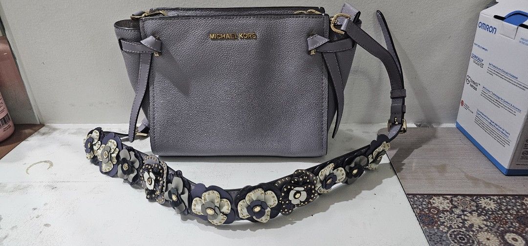 Michael Kors Grey Leather Handbag with Embellished Strap lp supee marked down (Category: Luxury Bags & Wallets) located in Davao. Submitted by sachigo (Listing ID 1463801429, Image 1). Description: - Genuine grey leather Michael Kors handbag - Detachable strap with beautiful floral and stud embellishments - Elegant gold hardware accents - Multiple interior compartments for organization - Clean interior, ready for its new owner - Versatile for bot